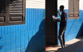 A field researcher knocks on a door.