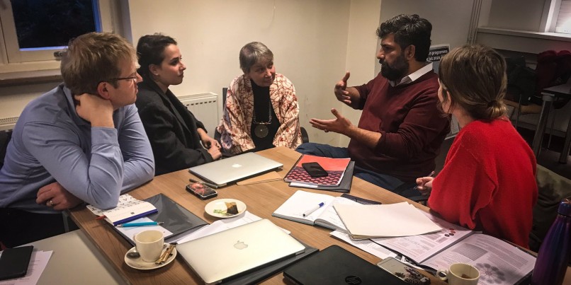 People around a table discussing