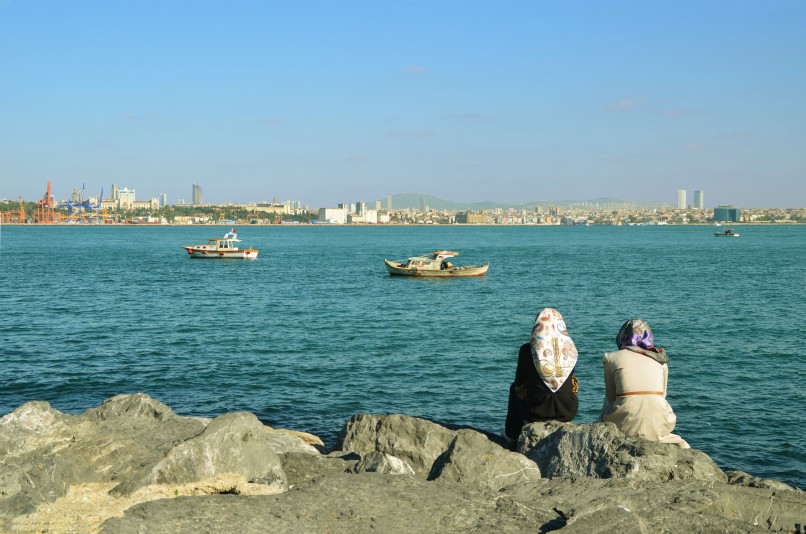 Two women sitting in front of bay