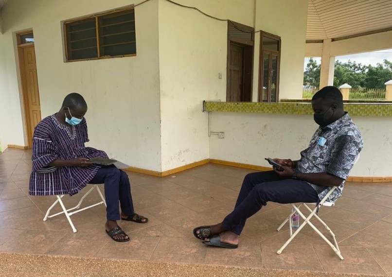 Ghana MIGNEX team conducting field research training outside using COVID-19 safe measures such as mask wearing and social distancing.